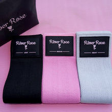 Load image into Gallery viewer, Three resistance bands, black, pink and grey with a pouch.
